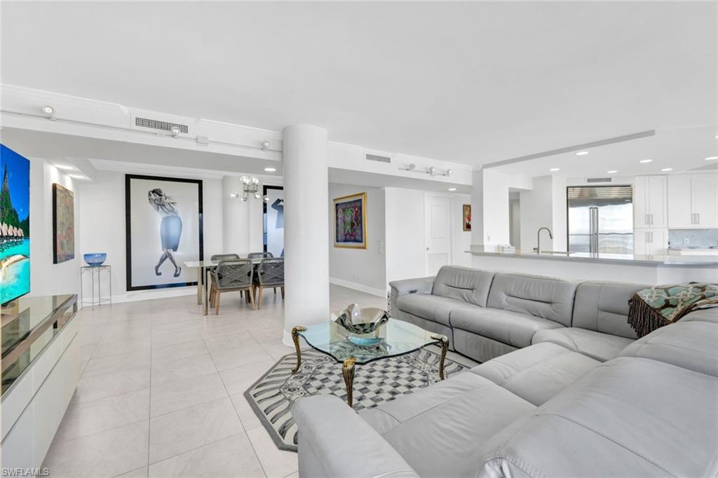 Tiled living room with sink and a water view