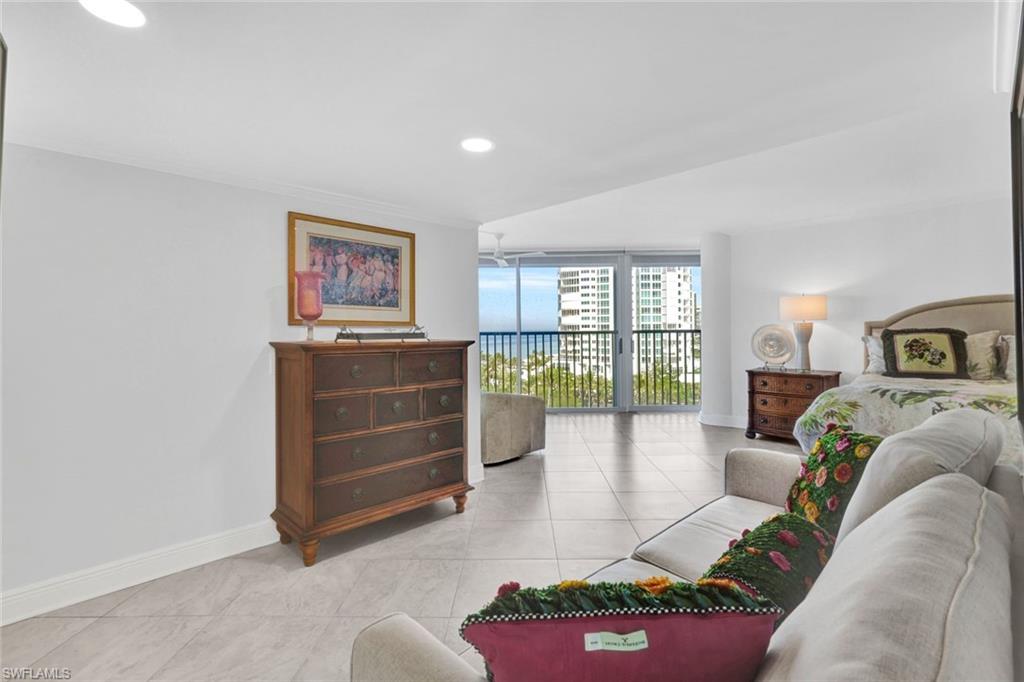Living room with light tile patterned floors and expansive windows
