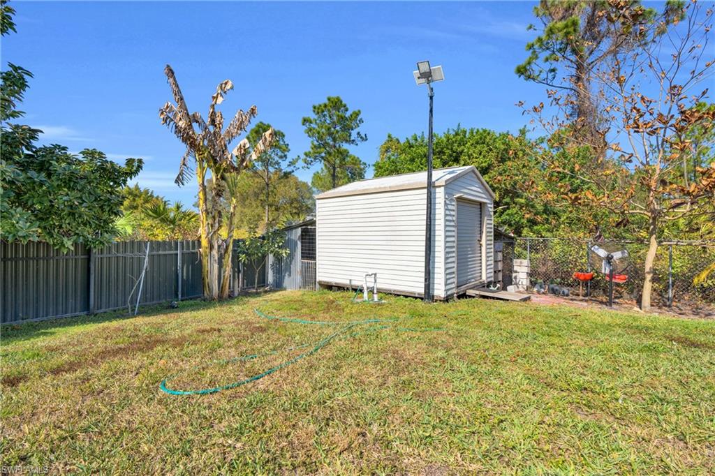 Fenced backyard with a shed
