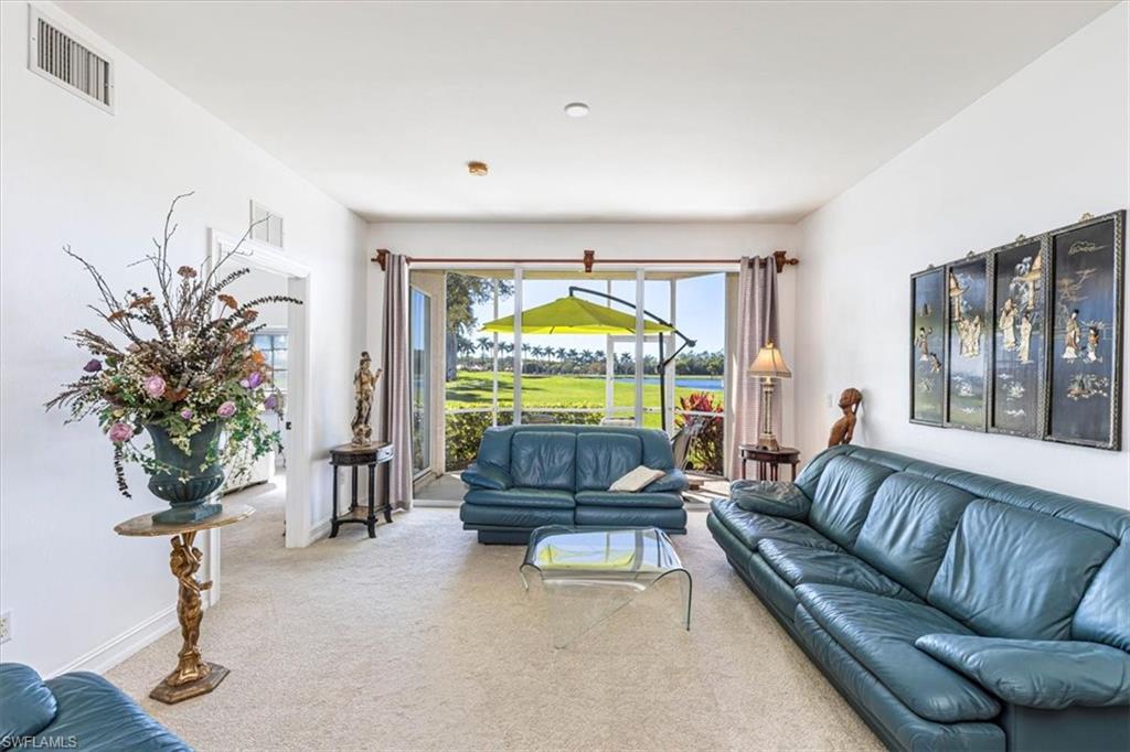 Carpeted living room with a sunroom
