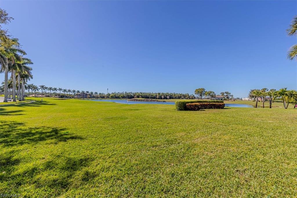 View of green lawn featuring a water view
