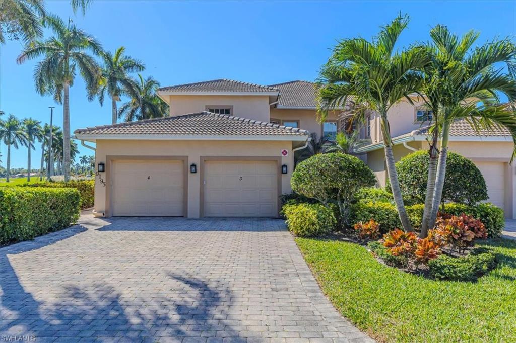 Mediterranean / spanish home with stucco siding, decorative driveway, a garage, and a tile roof