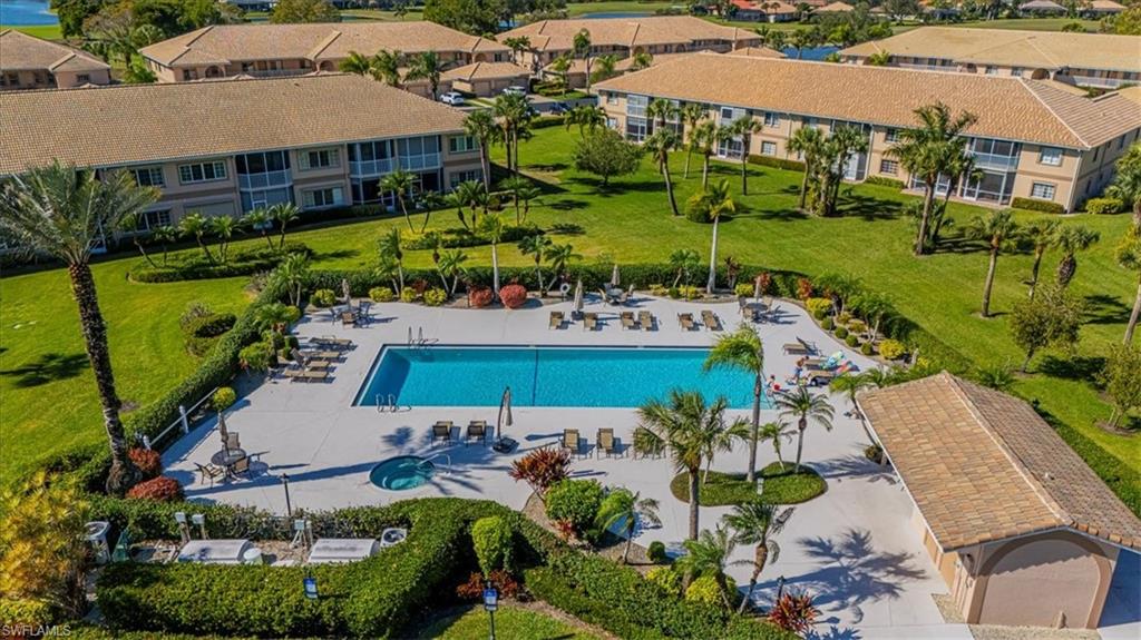Community pool with a patio and a yard