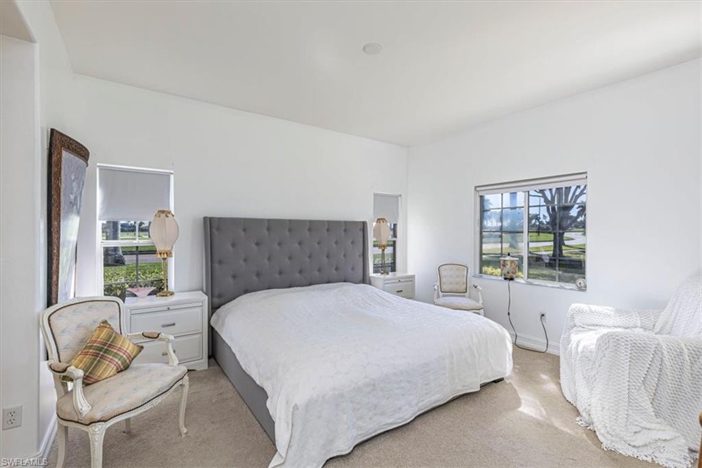 Bedroom featuring carpet flooring and baseboards