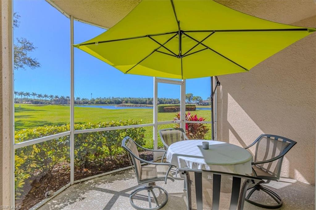 Sunroom with outdoor dining area and a water view