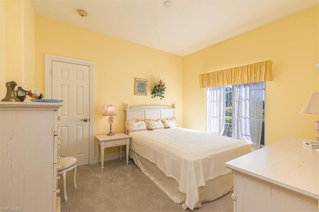Bedroom featuring light carpet and access to outside