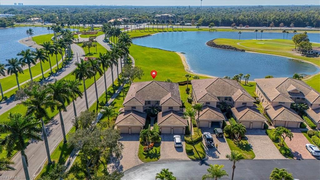 Drone / aerial view of a large body of water and a local golf course