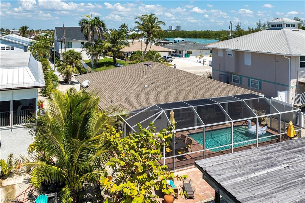 Screened pool, residential view, and a patio area