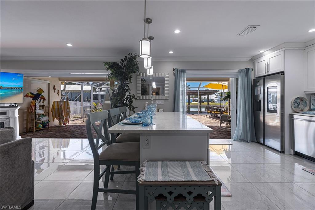 Dining space featuring marble finish floor, recessed lighting, crown molding