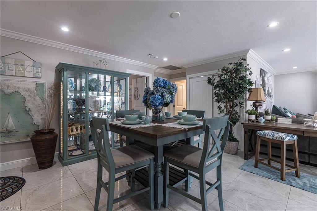 Dining room featuring baseboards, recessed lighting, and crown molding