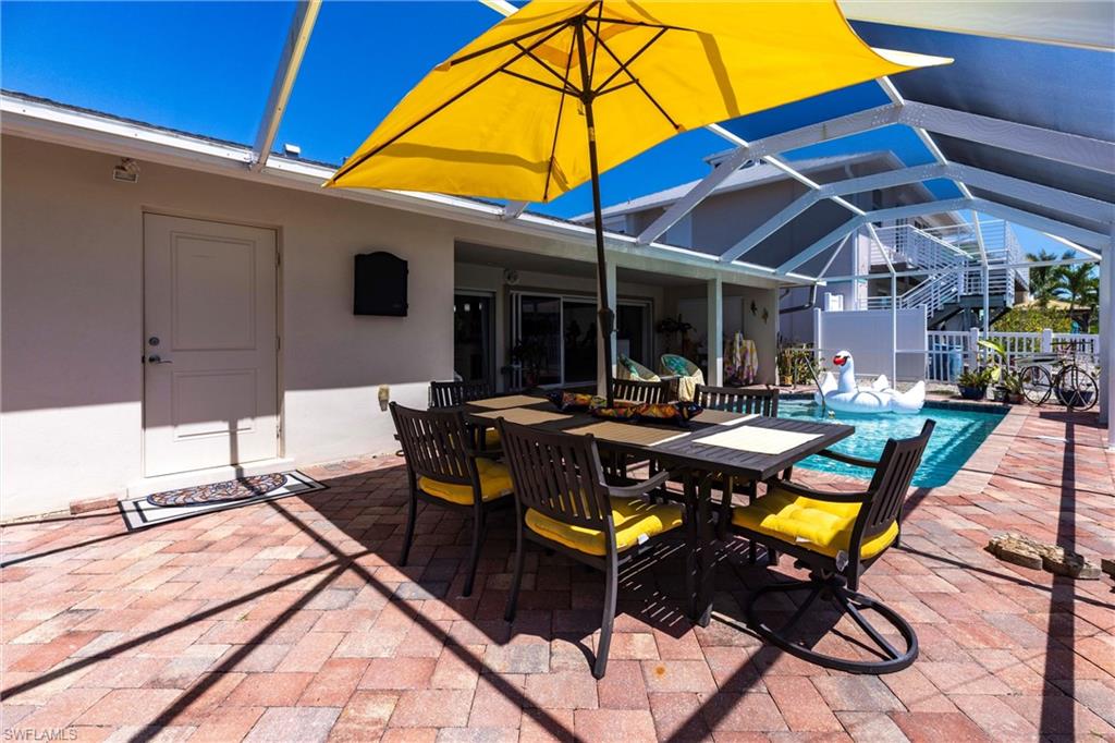 View of patio / terrace with screen enclosure, outdoor dining area, and pool
