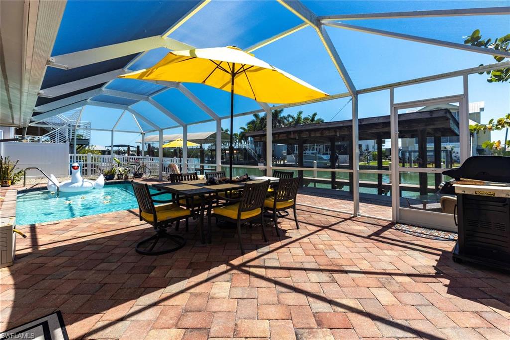 View of patio featuring screen enclosure and an outdoor pool
