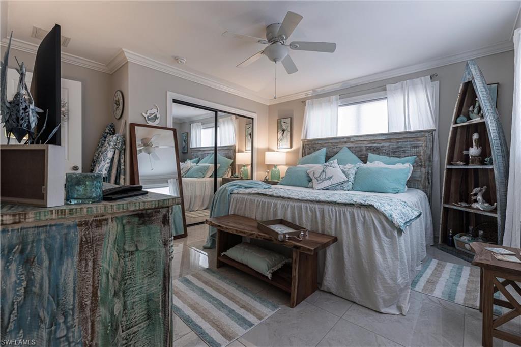Bedroom with ornamental molding, a closet, and ceiling fan