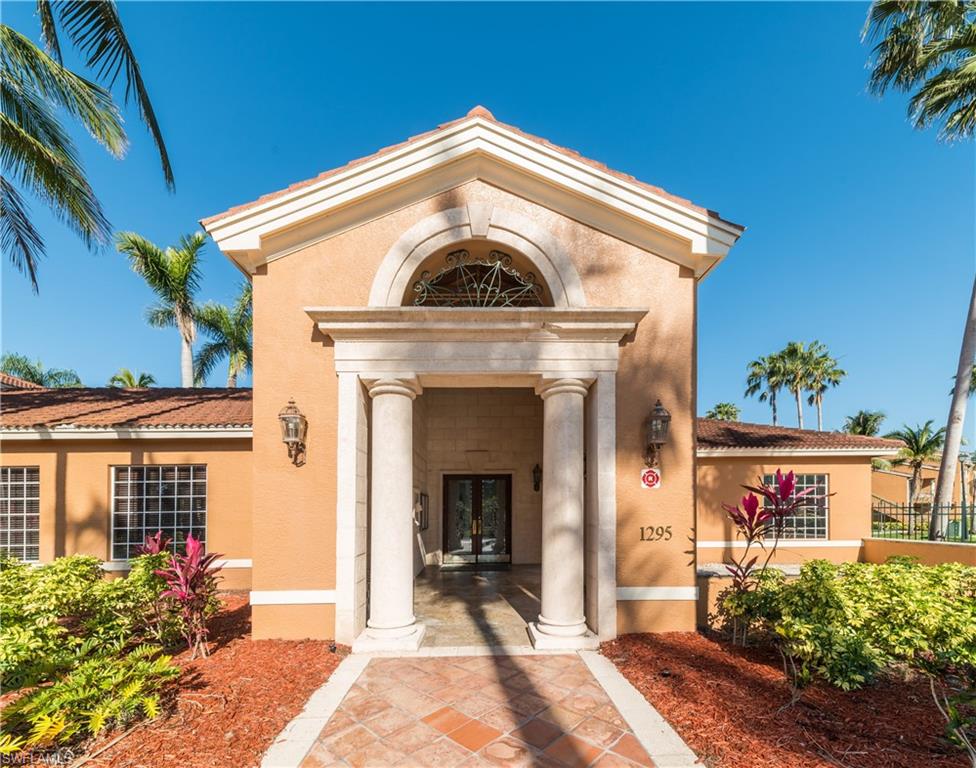 Doorway to property featuring french doors and stucco siding