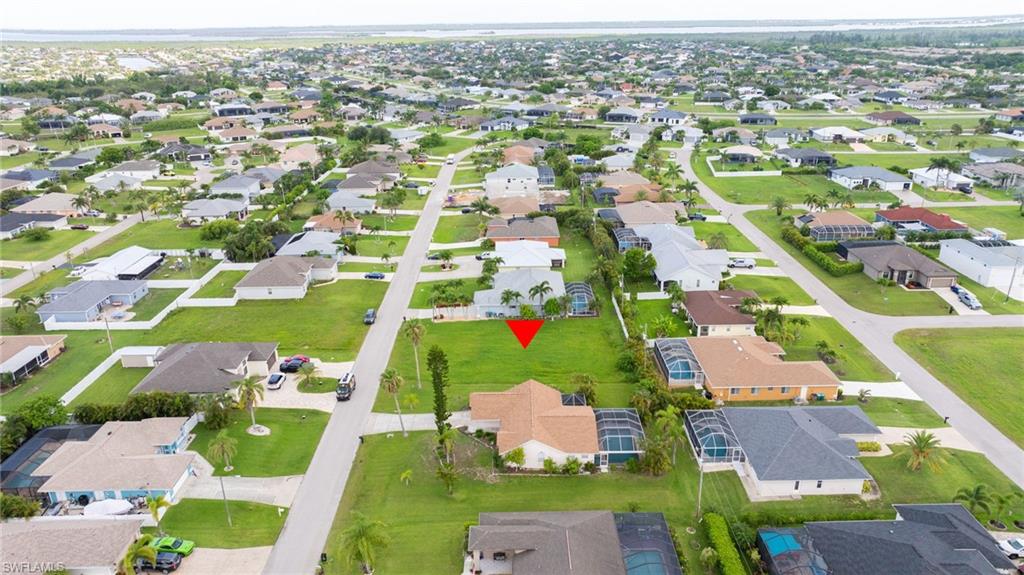 Aerial view of property's location featuring nearby suburban area
