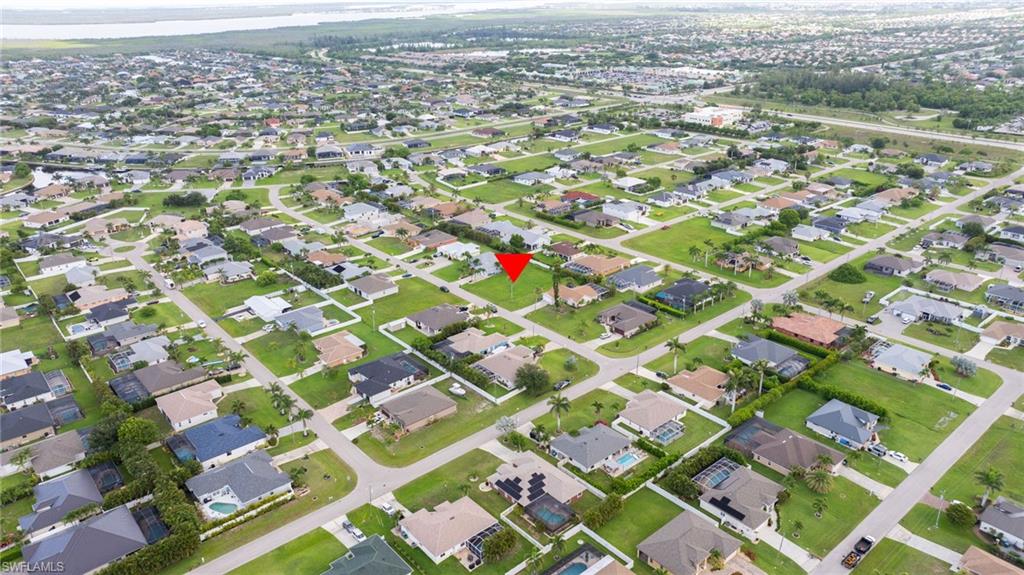Aerial overview of property's location featuring nearby suburban area