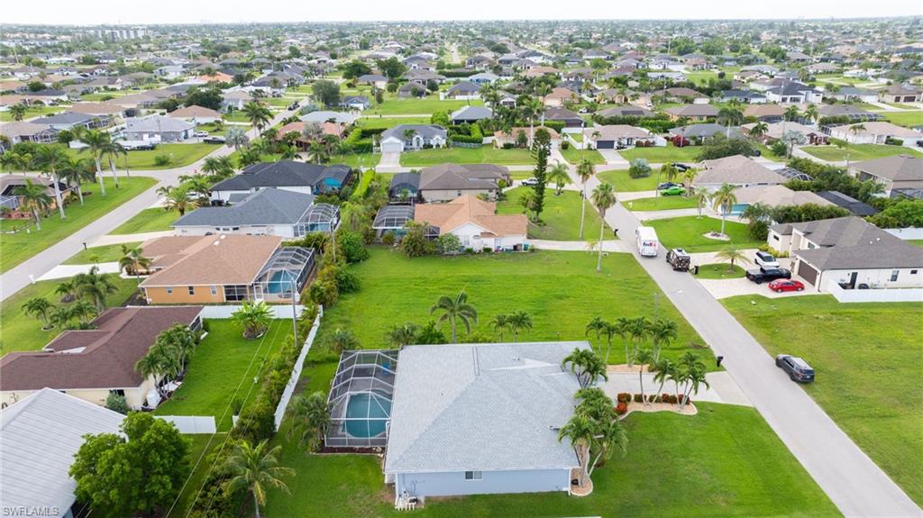Aerial view of property's location with nearby suburban area