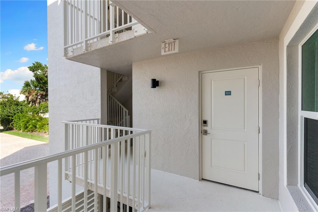 Property entrance featuring stucco siding