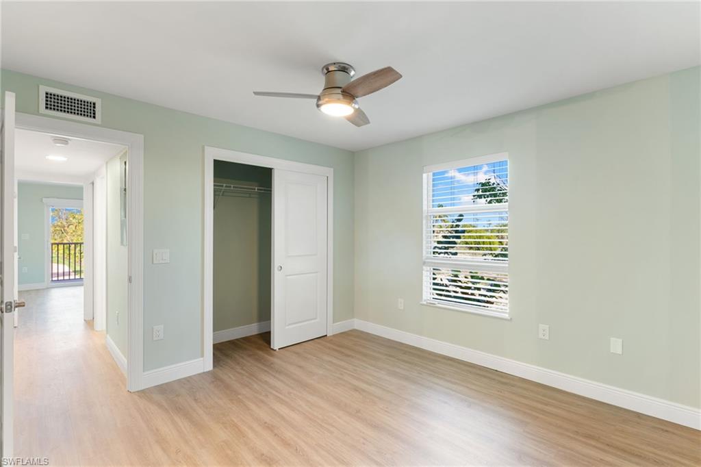 Unfurnished bedroom with a closet, light wood finished floors, and ceiling fan