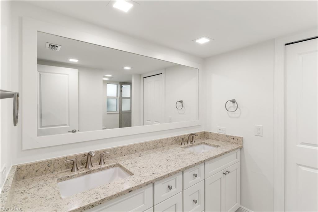 Primary bathroom featuring double vanity and recessed lighting