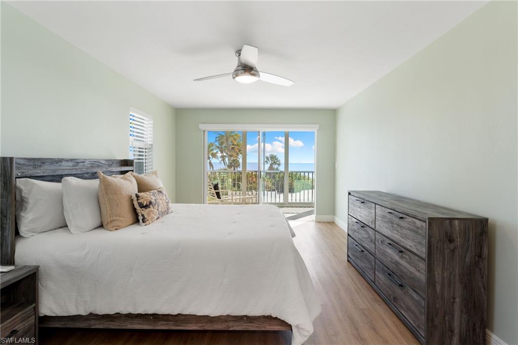 Primary Bedroom featuring light wood-style flooring, access to outside, and ceiling fan