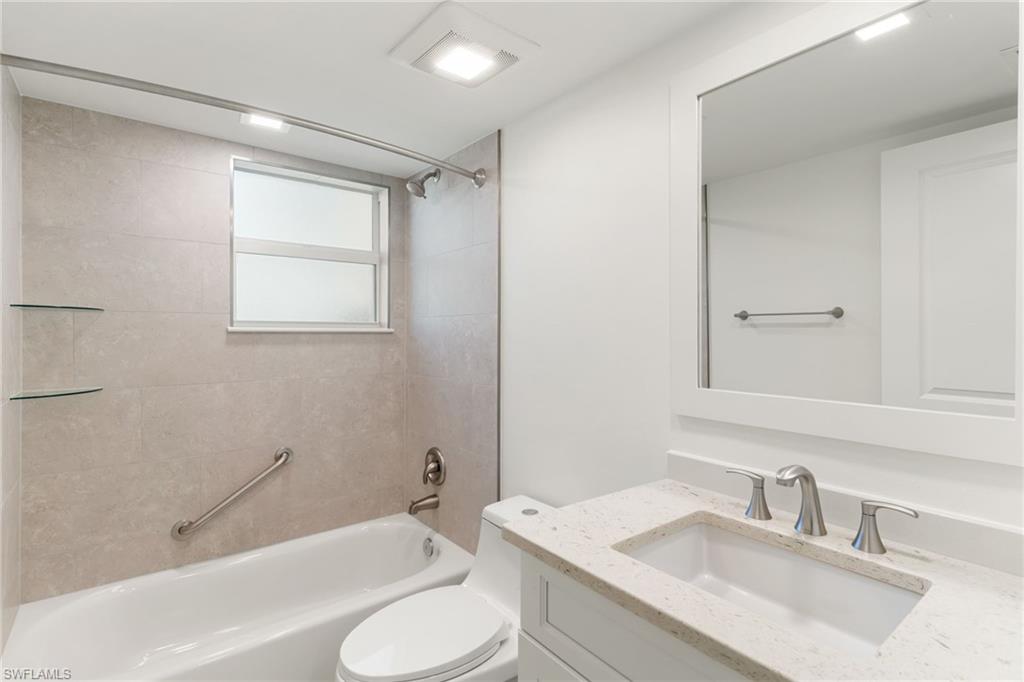 Bathroom with vanity and shower / tub combination