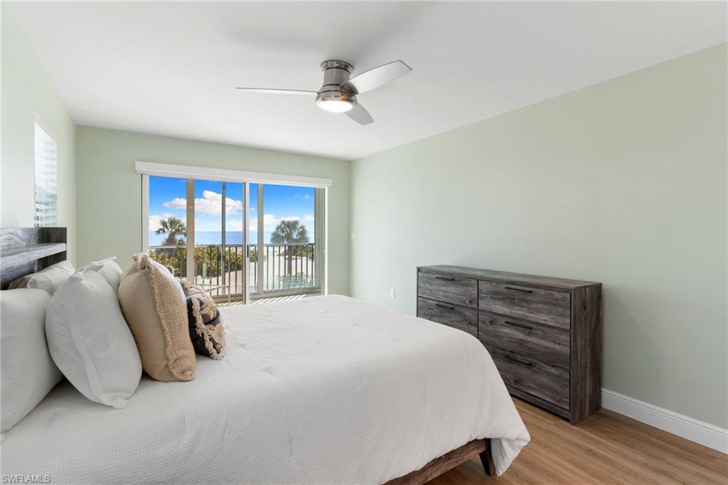 Primary Bedroom with wood finished floors and a ceiling fan