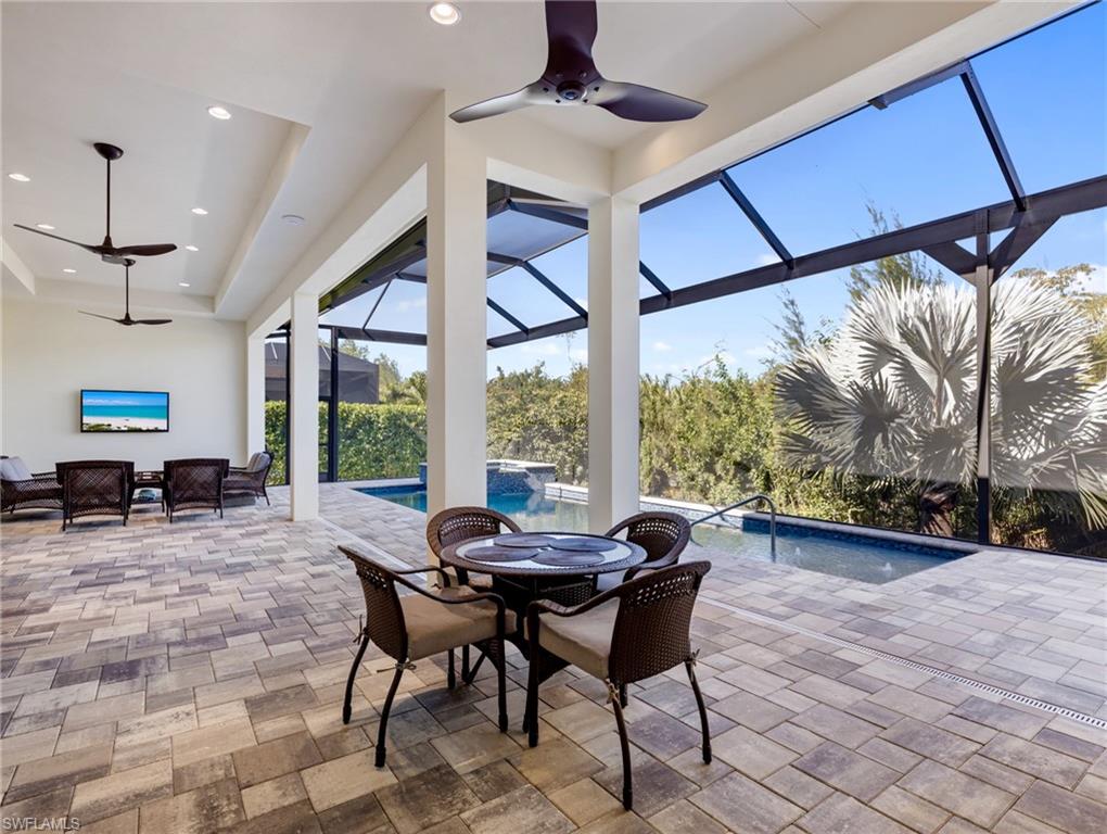 View of patio with a ceiling fan, outdoor dining area, a lanai, and a sunroom