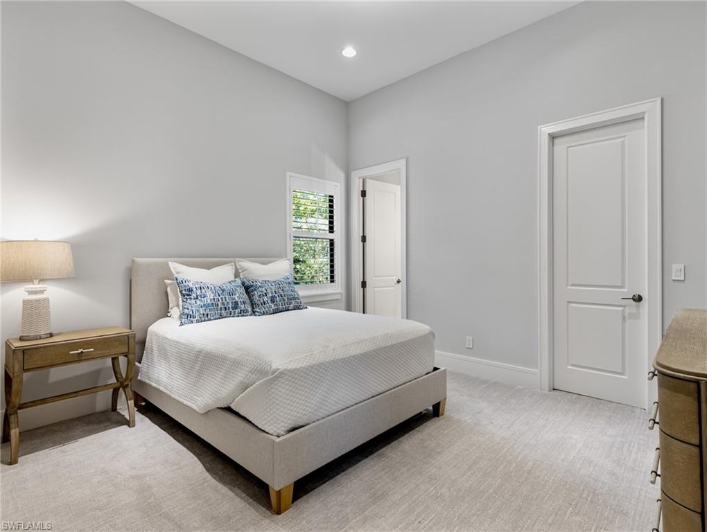 Bedroom featuring light colored carpet and recessed lighting