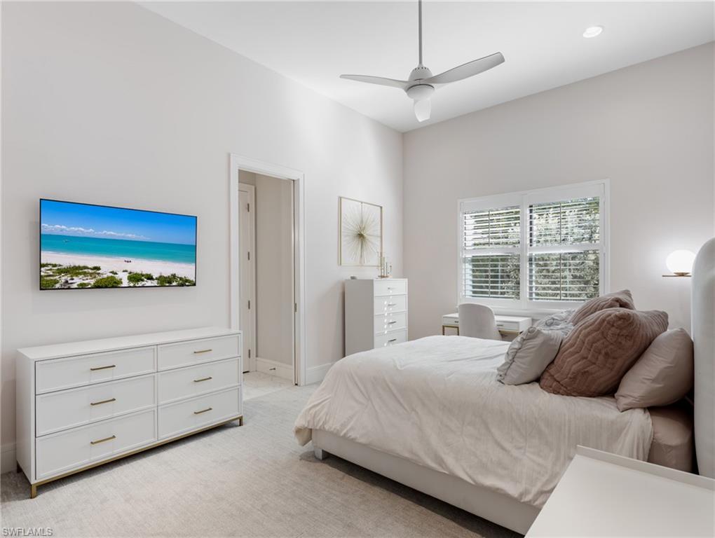 Bedroom featuring light colored carpet and ceiling fan