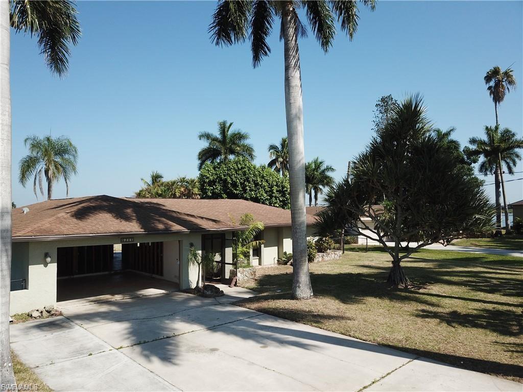 View of front of house featuring concrete driveway, a front yard, and stucco siding