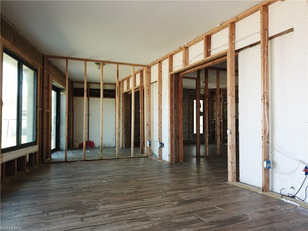 Miscellaneous room with dark wood-style flooring