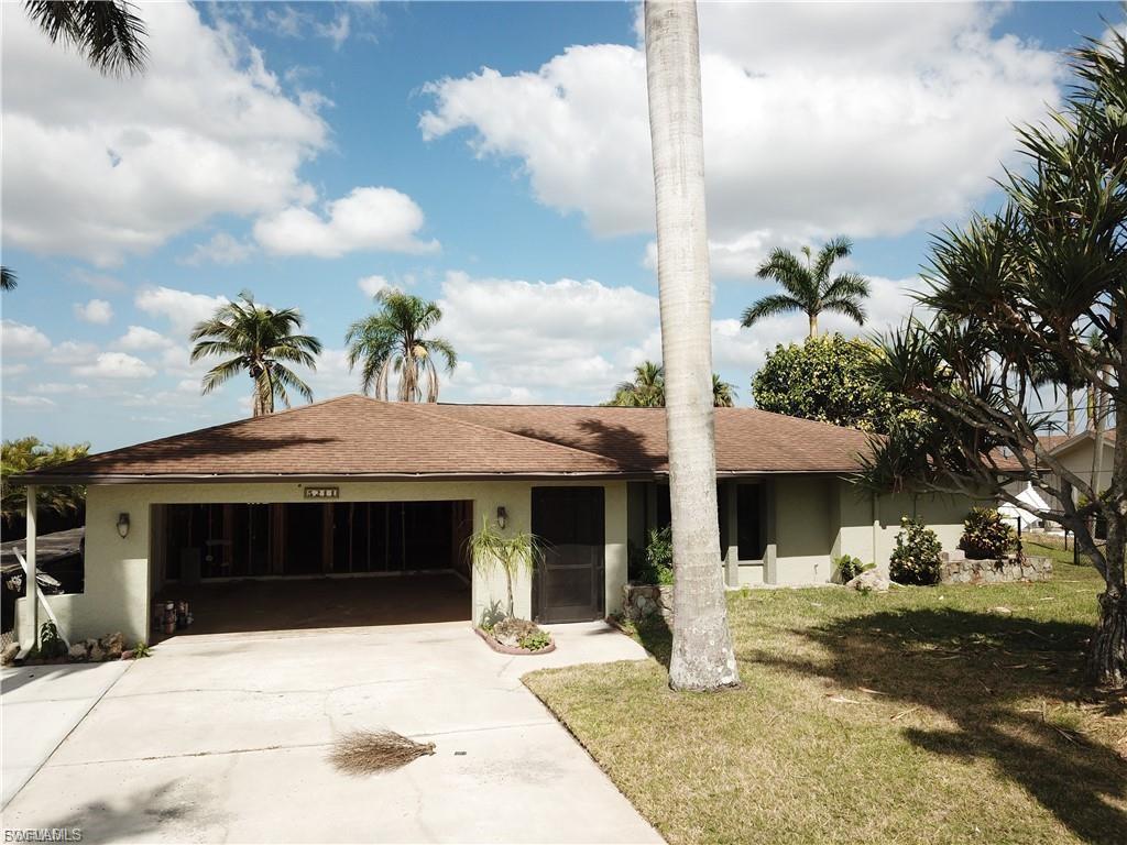Ranch-style home featuring concrete driveway, a garage, a front yard, and stucco siding