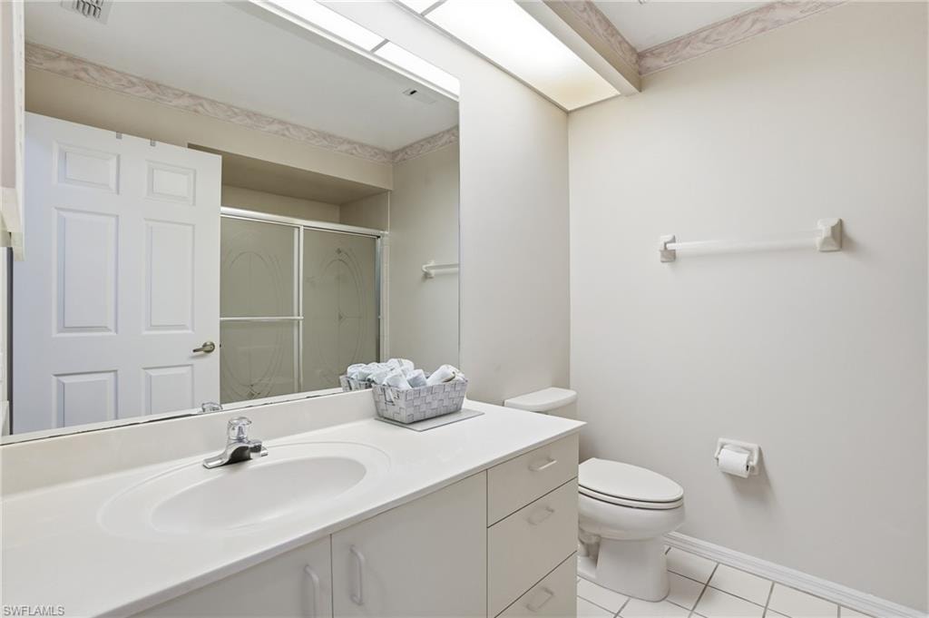 Guest Bathroom featuring a stall shower, vanity, and light tile patterned floors