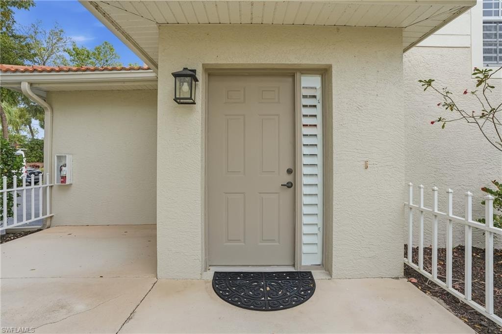 Doorway to property with private patio area