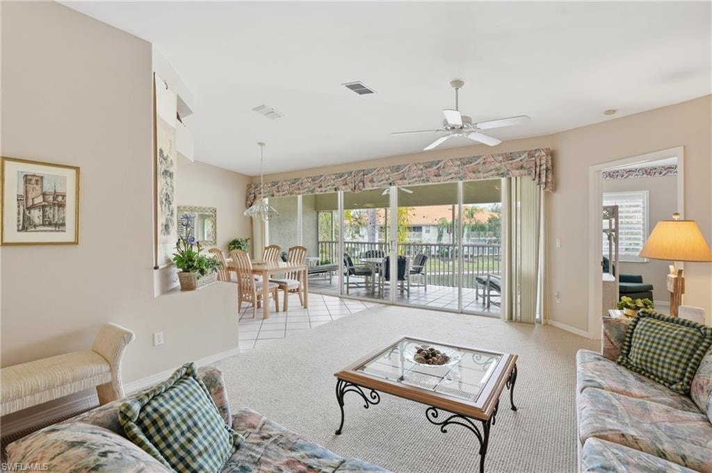 Living area with carpet floors and a ceiling fan