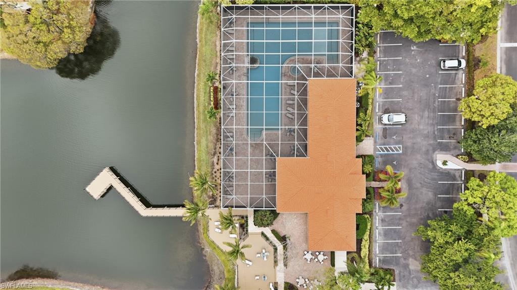 Drone / aerial view of lake and fishing pier, clubhouse pools and community room