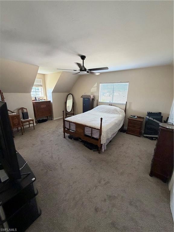 Bedroom featuring vaulted ceiling, light colored carpet, and a ceiling fan