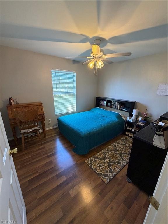 Bedroom featuring dark wood-style floors and ceiling fan