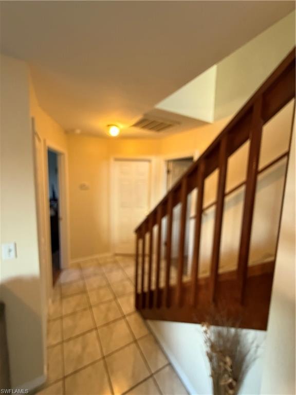Stairs featuring tile patterned flooring