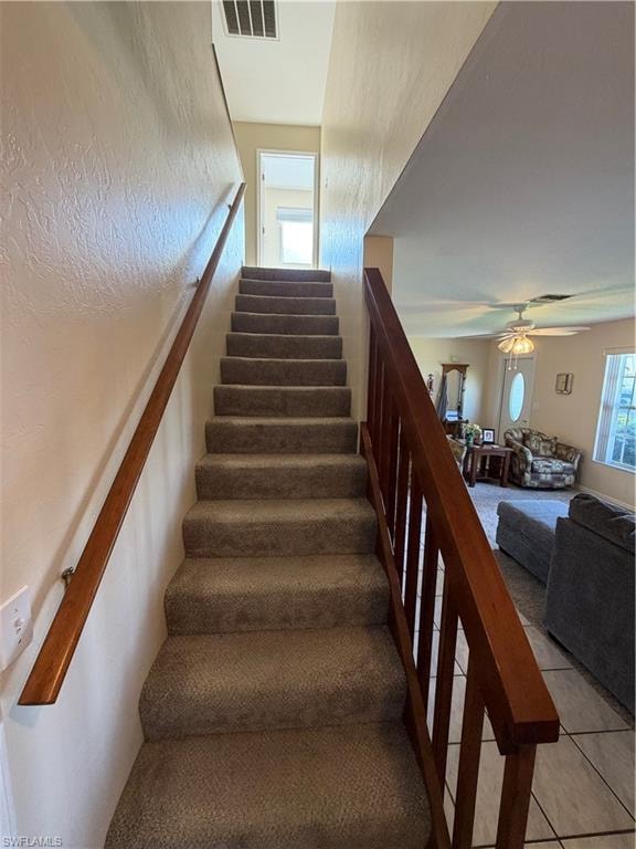 Staircase featuring tile patterned floors