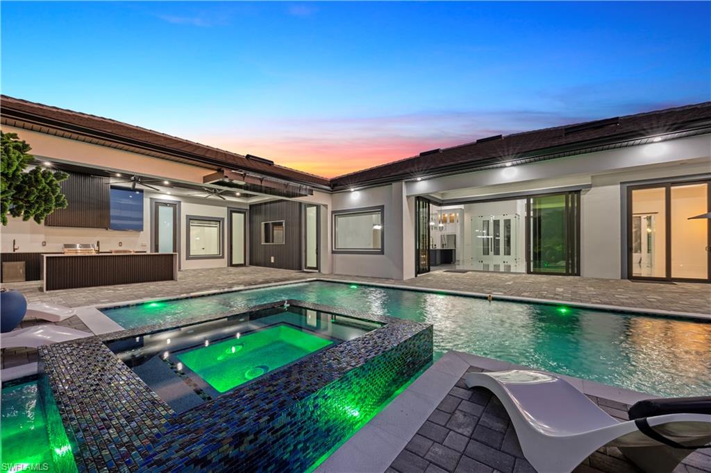 View of pool featuring a patio and a pool with connected hot tub