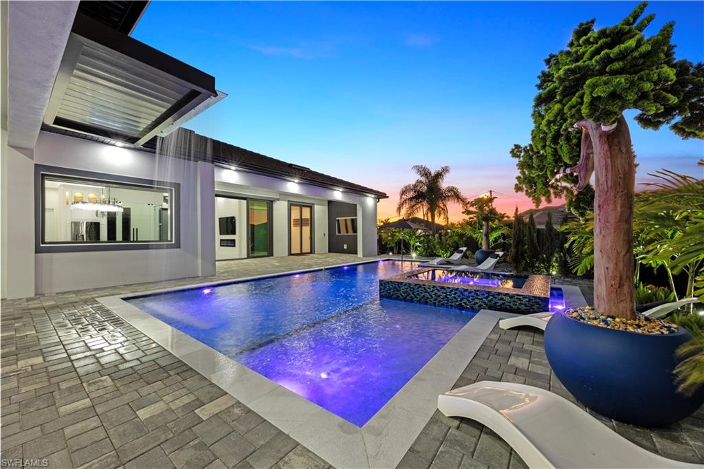 View of pool featuring a patio and a pool with connected hot tub