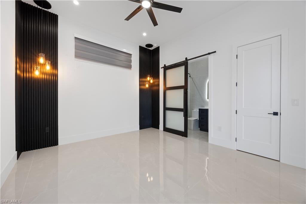 Mother in Law bedroom featuring a barn door, ensuite bath, ceiling fan, and recessed lighting