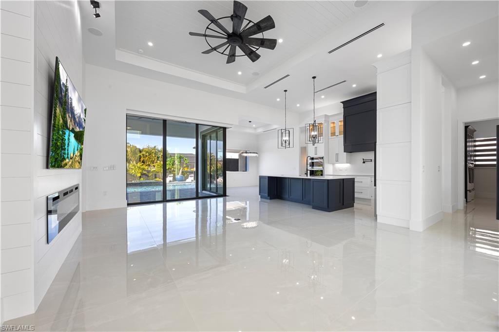 Unfurnished living room featuring recessed lighting and a tray ceiling