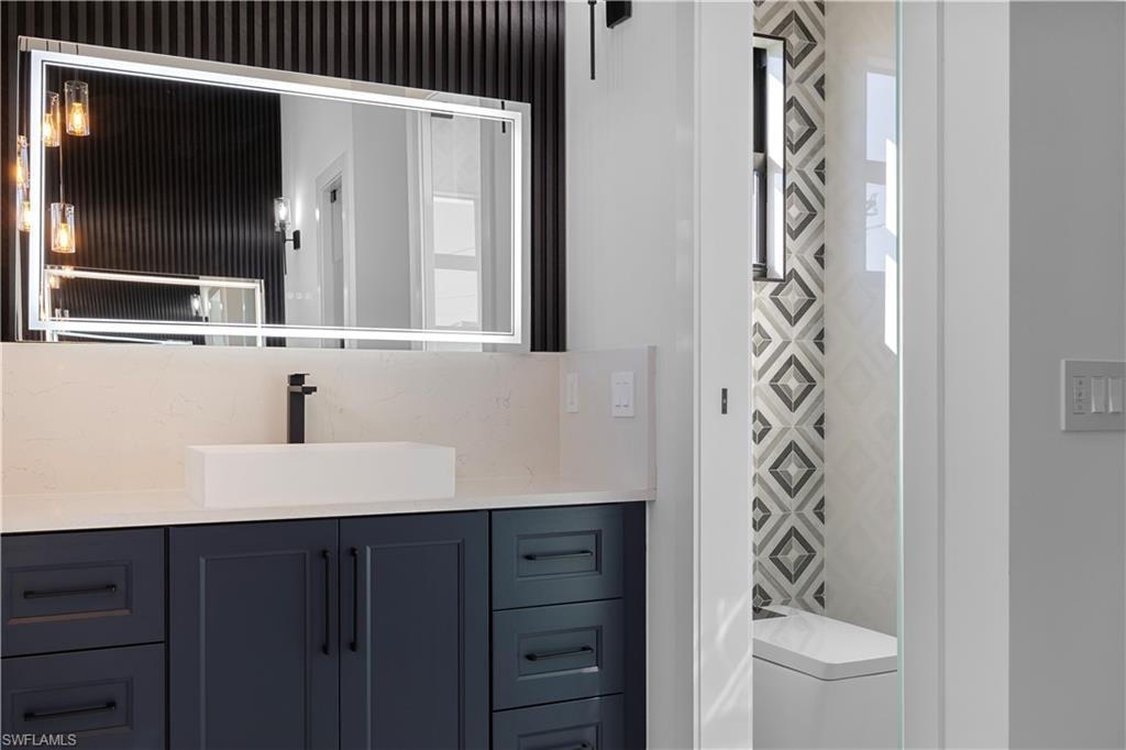 Bathroom featuring vanity and toilet