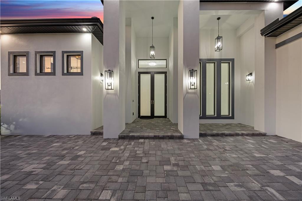 Doorway to property featuring stucco siding
