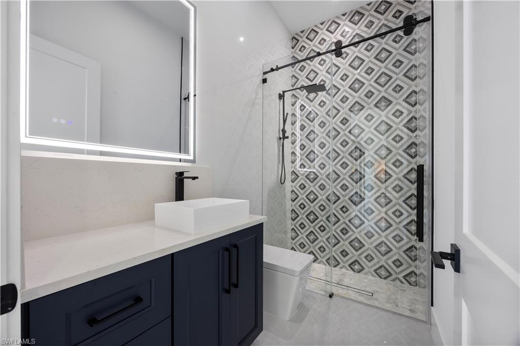 Bathroom with vanity and a shower stall