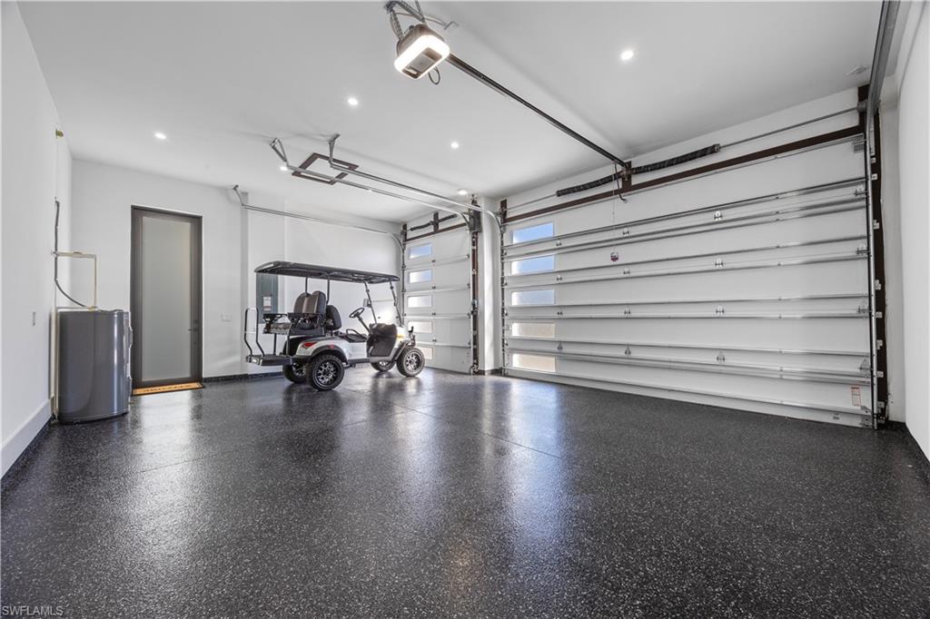 Garage featuring recessed lighting and a garage door opener