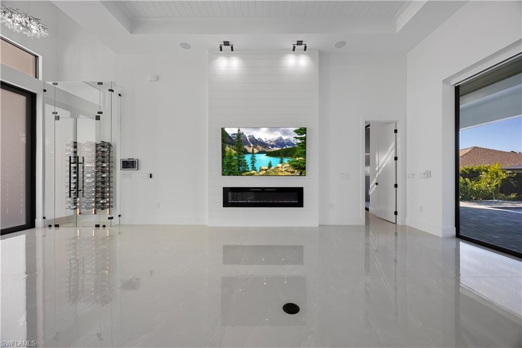 Unfurnished living room featuring a fireplace and wooden ceiling
